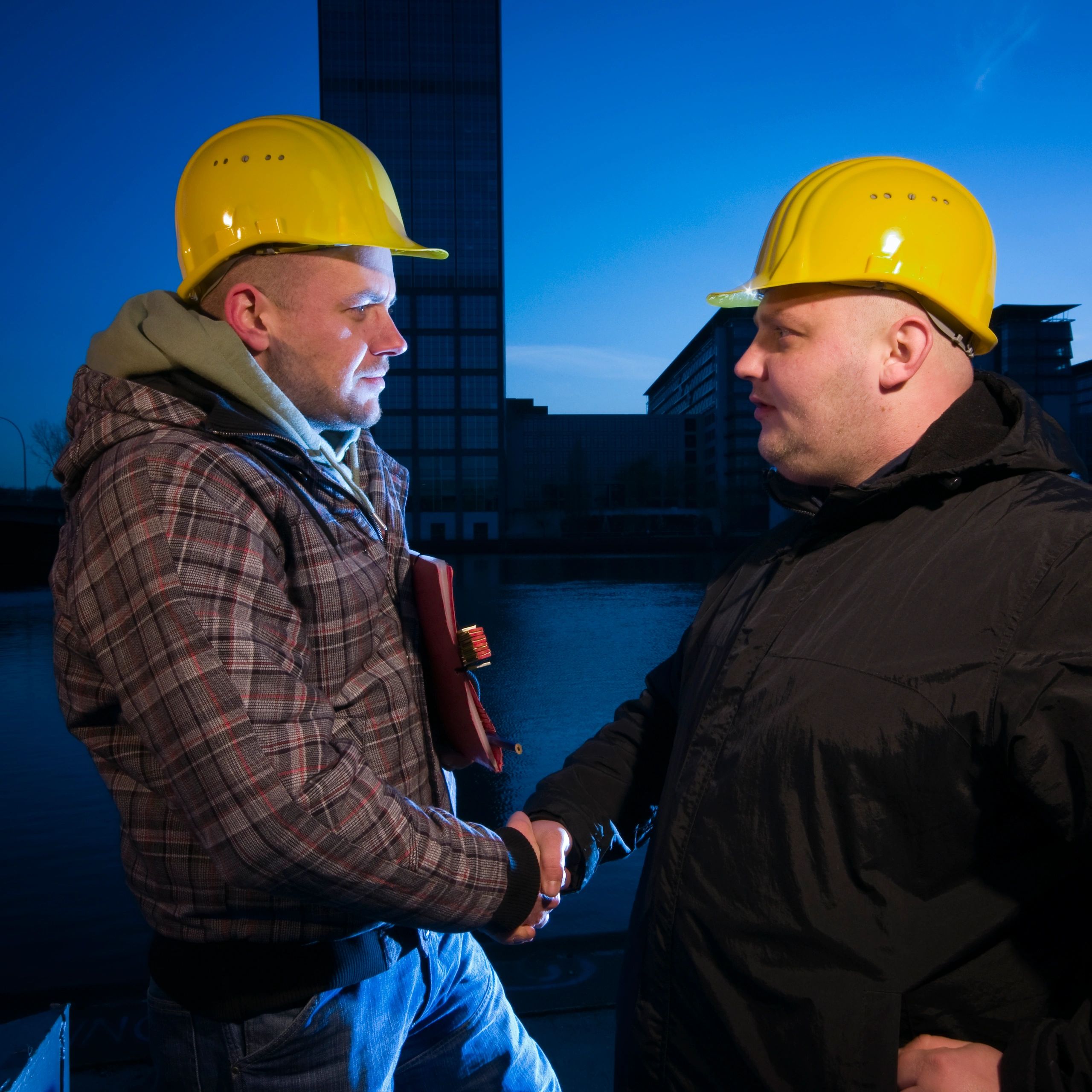 Two professionals shaking hands at a job site