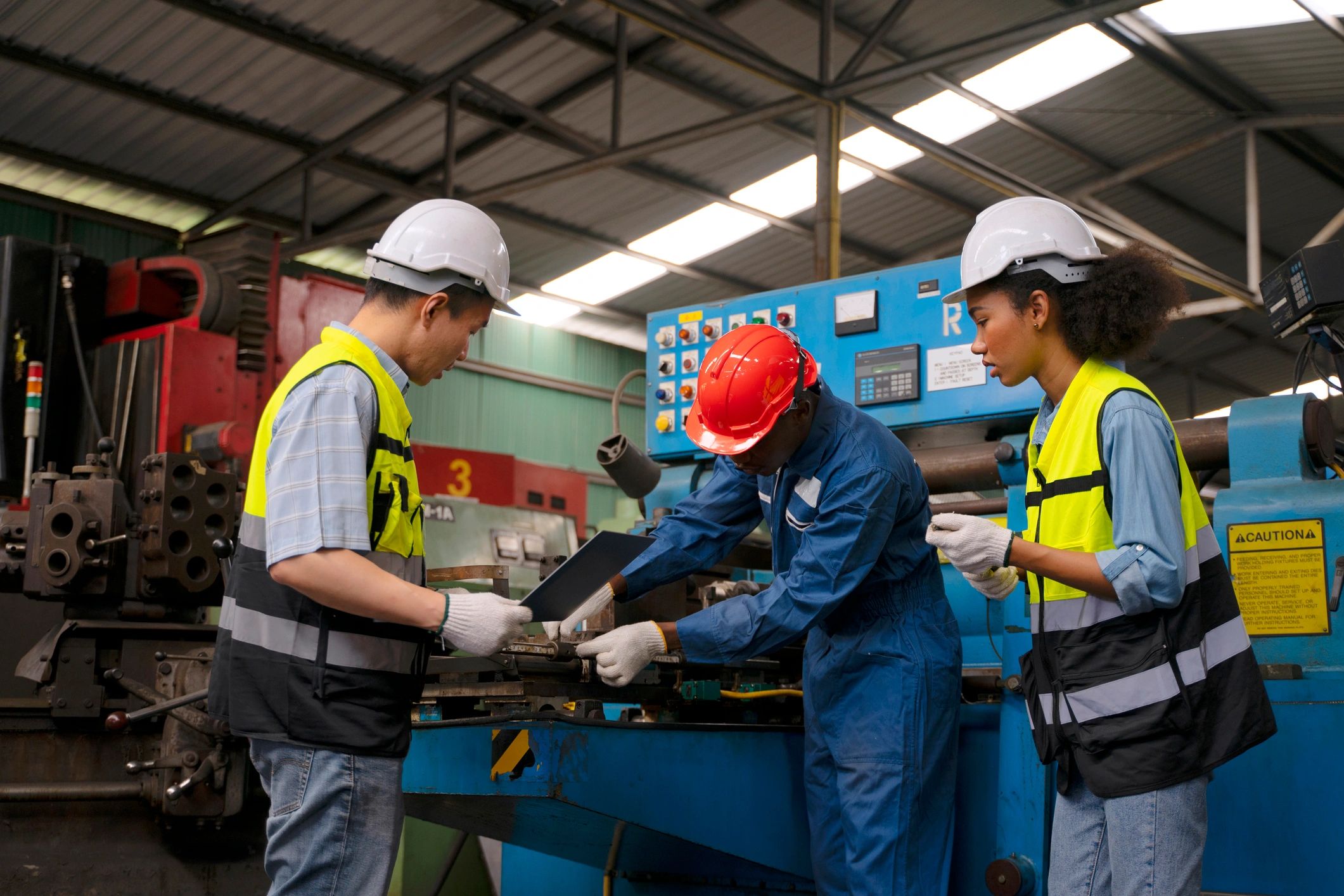 Industrial workers operating machinery in a manufacturing facility
