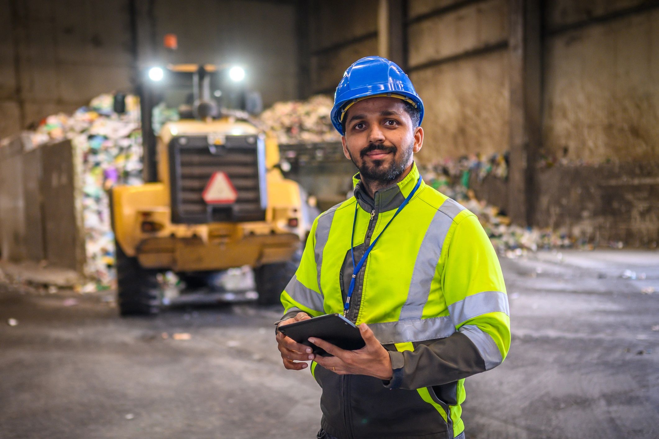 Industrial technician using a tablet in a machinery facility