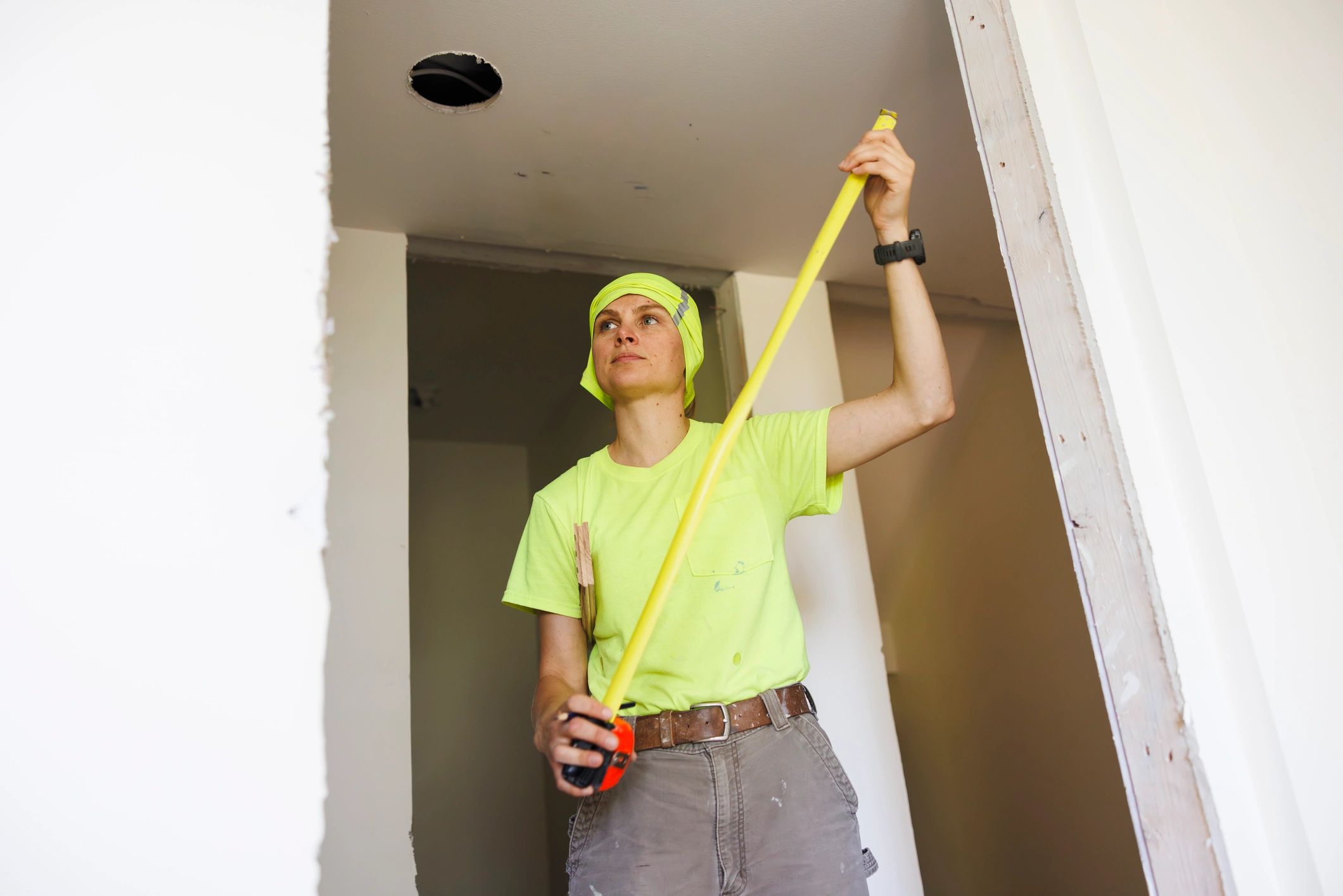 Contractor measuring inside a residential renovation space