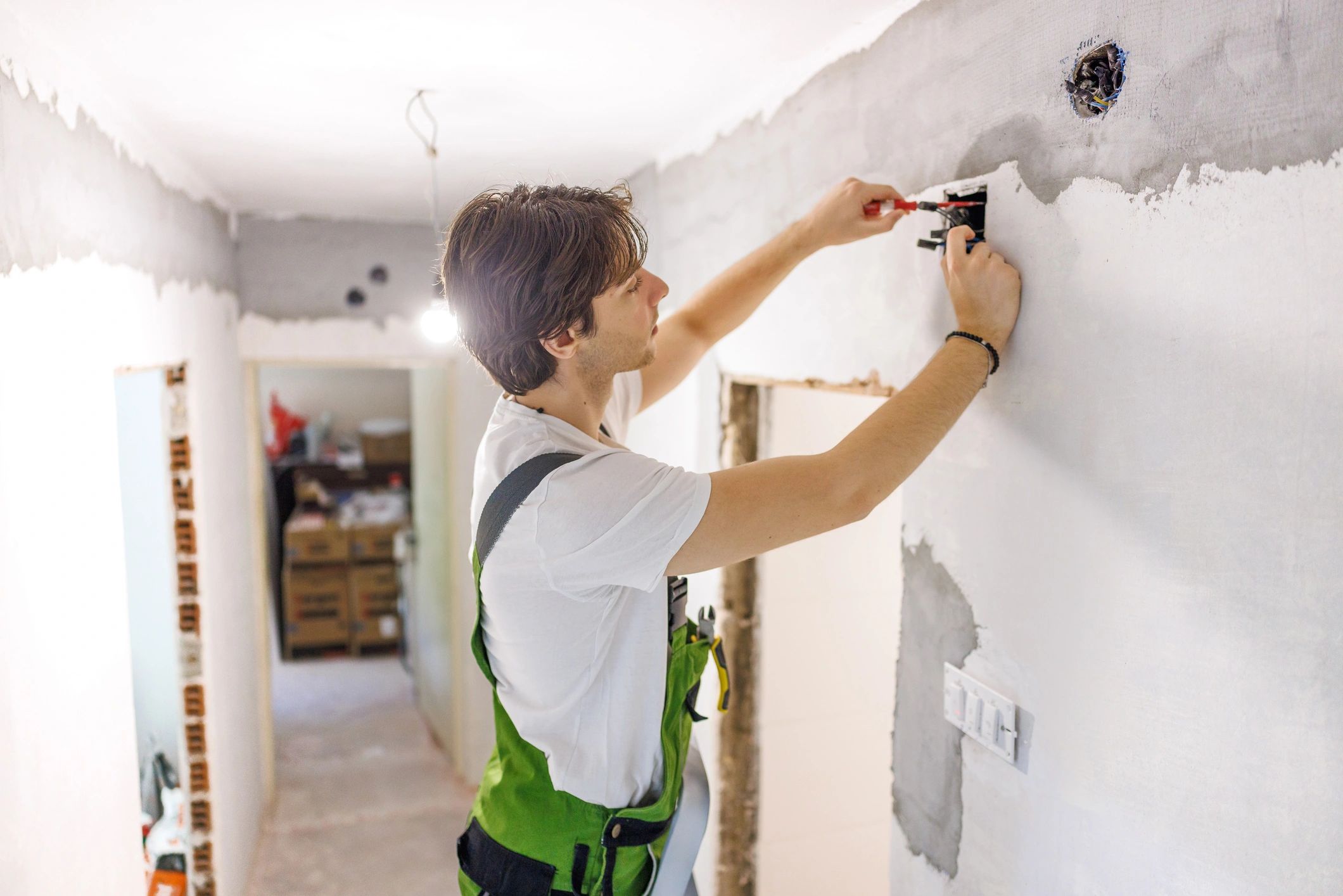 Electrician installing wiring during a home renovation